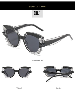 Macro detail of cat eye sunglasses with polygonal crystal frame and dark black lenses