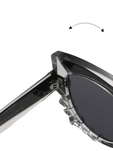 Detail of reinforced metal hinge and size specs on grey translucent cat eye sunglasses