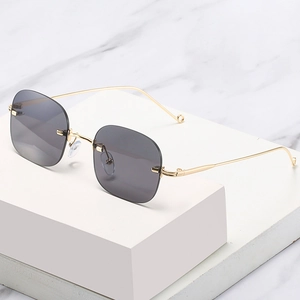 Retro rimless sunglasses with gradient grey lenses and slender gold metal temples
