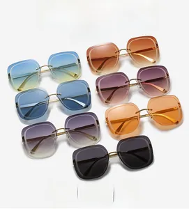 Detail of square oversized sunglasses showing gradient lenses and gold metal temples