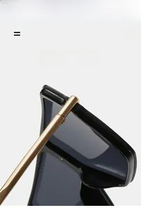 Detail view of lightweight flexible gold temples and black oversized sunglasses frame