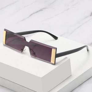 Futuristic purple rectangle sunglasses with gold accents on a white geometric stand