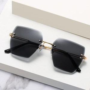 Fashionable rimless square sunglasses with gradient grey lenses and gold metal frame