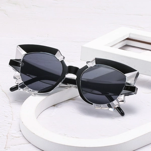 Retro polygon cat eye sunglasses with black geometric frame on white minimalist display