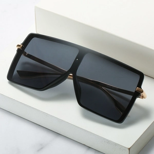 Oversized black square sunglasses with thick frames and golden metal temple details