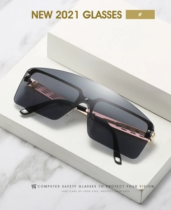 Macro detail of oversized shield sunglasses with rose gold metal temples and gray lenses