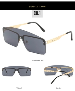 Detail view of gold metal frames and grey one-piece lenses on trendy sunglasses