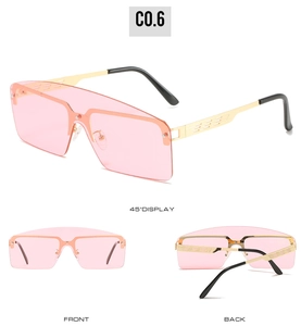 Detail view of pink oversized rimless sunglasses with gold镂空 metal frame and nose pads