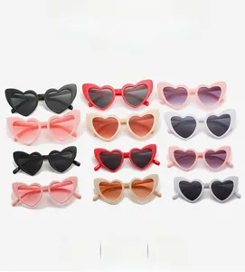 Flat lay grid showing heart-shaped sunglasses in multiple colors and vintage cat-eye frames
