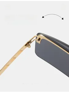 Detail shot of durable metal hinge on golden frame sunglasses with dark grey lenses