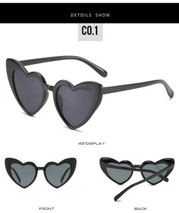 Detailed views of black heart-shaped sunglasses with dark lenses and glossy finish