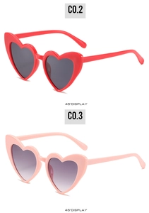 Detailed 45-degree view of trendy heart-shaped sunglasses in red and pink frames