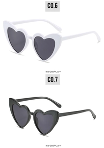 Detail view of heart-shaped sunglasses in black and white frames at 45 degree angle