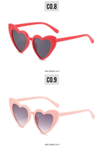 Detailed 45-degree view of red and pink heart-shaped sunglasses with gradient lenses