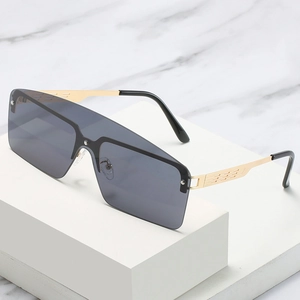Fashionable oversized one-piece sunglasses with dark grey lenses and golden metal frames