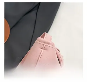 Close-up of high-quality stitching and texture on the soft pink leather shoulder bag
