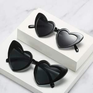 Chic black heart-shaped sunglasses for women on premium white marble background