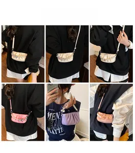 Detail showing various colors of pleated cloud bags with pearl and heart chains