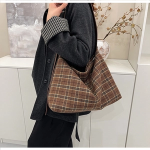 Detailed view of the brown plaid tote bag material and large capacity commuter style