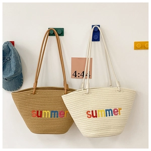 Detail of summer embroidery on large handmade woven tote bags for beach travel