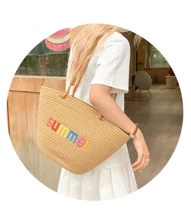 Detail of hand-woven tote bag with colorful summer embroidery for beach holidays