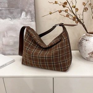 Classic plaid tote bag with brown leather straps and spacious interior for daily commute