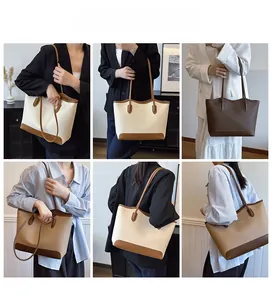 Detail view of large tote bag with contrast colors and trapezoid shape on model