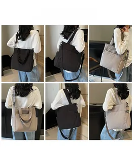 Detail view of large canvas tote bag with side pockets shown in black and khaki colors