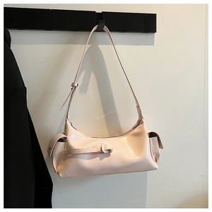 Glossy pale pink baguette bag featuring adjustable shoulder strap and side flap pockets