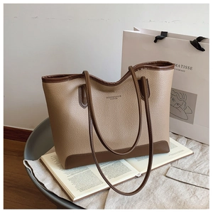 Detail of vintage patchwork tote bag in beige lychee leather with brown handles
