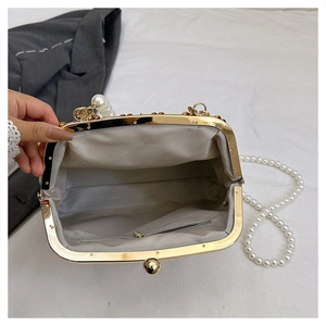 Détail du sac de soirée à chaîne perlée avec cadre doré et doublure à chevrons