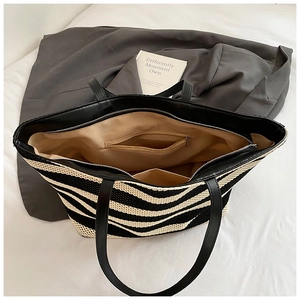 Detail view of the zebra stripe tote bag interior with fabric lining and zipper pocket