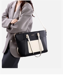 Close-up of contrast color tote bag with black body and cream white pocket details
