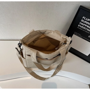 Top view of large capacity beige canvas tote bag showing interior storage and pockets