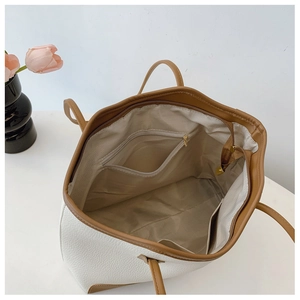 Interior view of large tote bag showing herringbone lining and zipper pocket detail