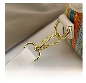 Detail of high-quality gold metal lobster clasp and colorful woven fiber texture