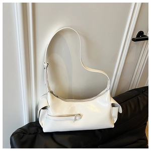 Detail view of white gloss shoulder bag featuring side pockets and a front decorative zipper