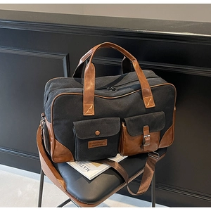 Detail of multi-functional travel bag with leather handles and metallic buckle closure