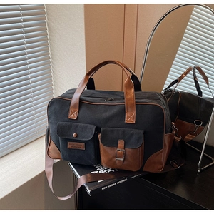 Detail of multi-functional travel bag featuring contrast stitching and large pockets