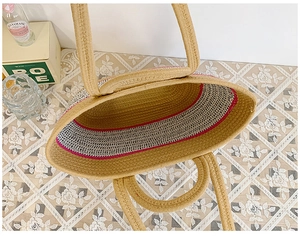Top view of large straw tote bag with pink striped lining and spacious interior