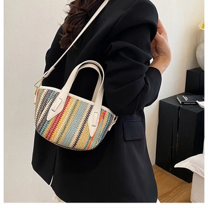 Detail of colorful rainbow striped woven tote bag with white leather handle and strap