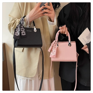 Detail of woven handles with checkered scarves on lychee texture tote bags