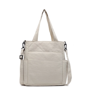 Minimalist beige nylon tote bag with top handles and adjustable shoulder strap