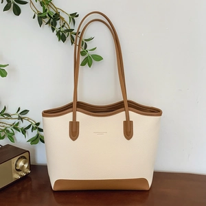 Large cream tote bag with caramel contrast trim and long shoulder straps for daily commute