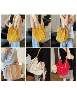 Detail showing various colors of crochet tote bags with colorful pom-poms on models