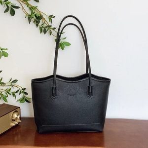 Large black pebbled leather tote bag with elegant thin shoulder straps and embossed logo
