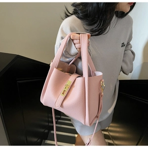 Pink lychee texture leather handbag with gold metal lock buckle and crossbody strap