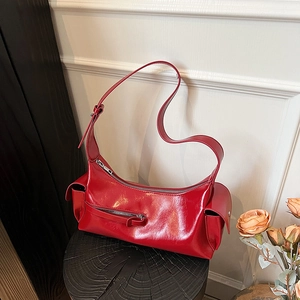 Retro red glossy leather baguette bag with functional utility pockets and shoulder strap