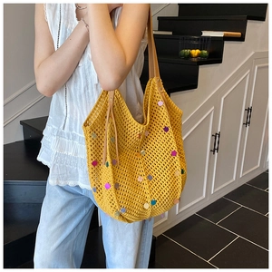 Detail of yellow knit tote with colorful sequins and brown faux leather shoulder strap