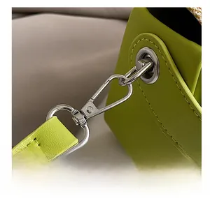 Close-up of high-quality silver metal hook and lime green leather shoulder strap